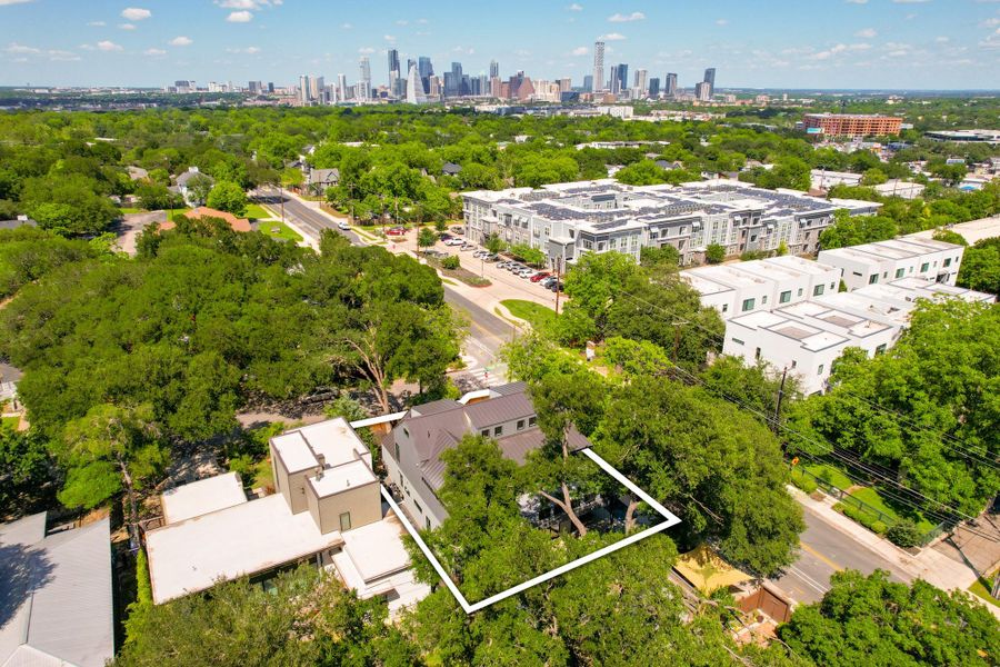Aerial perspective showcasing a modern residence nestled among mature trees Aerial perspective showcasing a modern residence nestled among mature trees