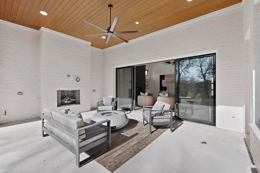 Gas logs and ceiling fan make this outdoor living space all season.