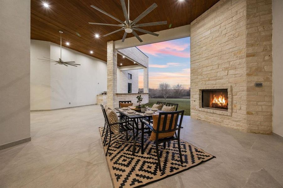 Outdoor Living area featuring a large fireplace, wooden ceiling, and ceiling fan