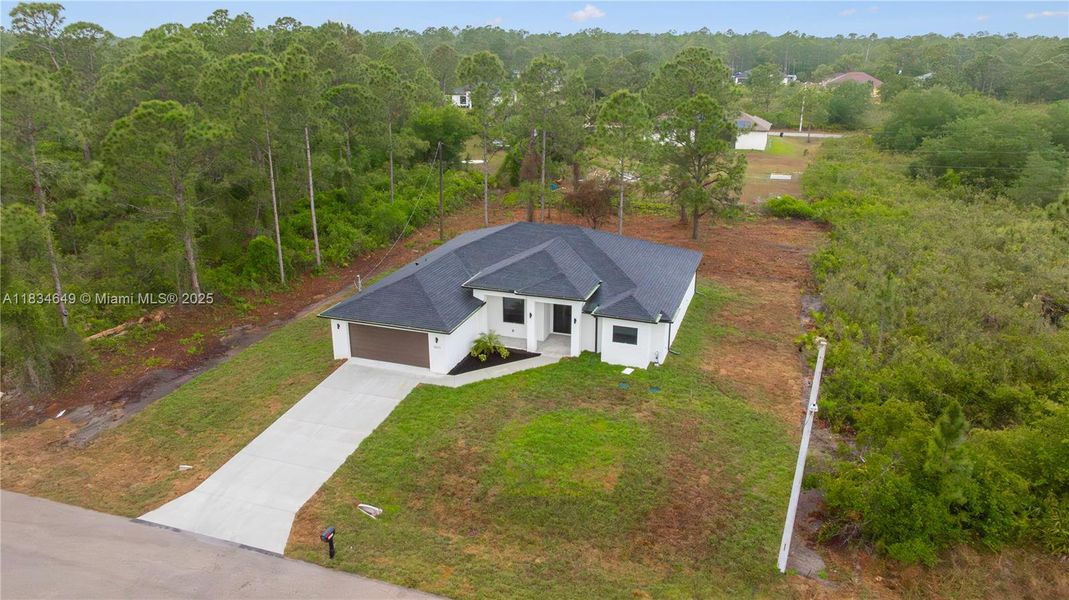 Front exterior of a new home in , Lehigh Acres, FL, highlighting curb appeal (Image 27).
