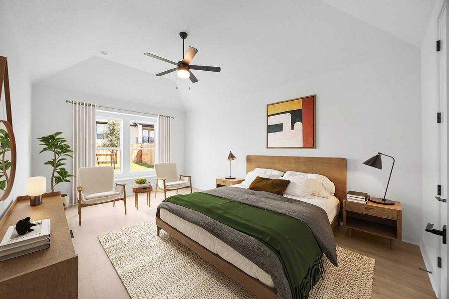 Bedroom featuring lofted ceiling, light wood-style floors, and a ceiling fan Bedroom featuring lofted ceiling, light wood-style floors, and a ceiling fan