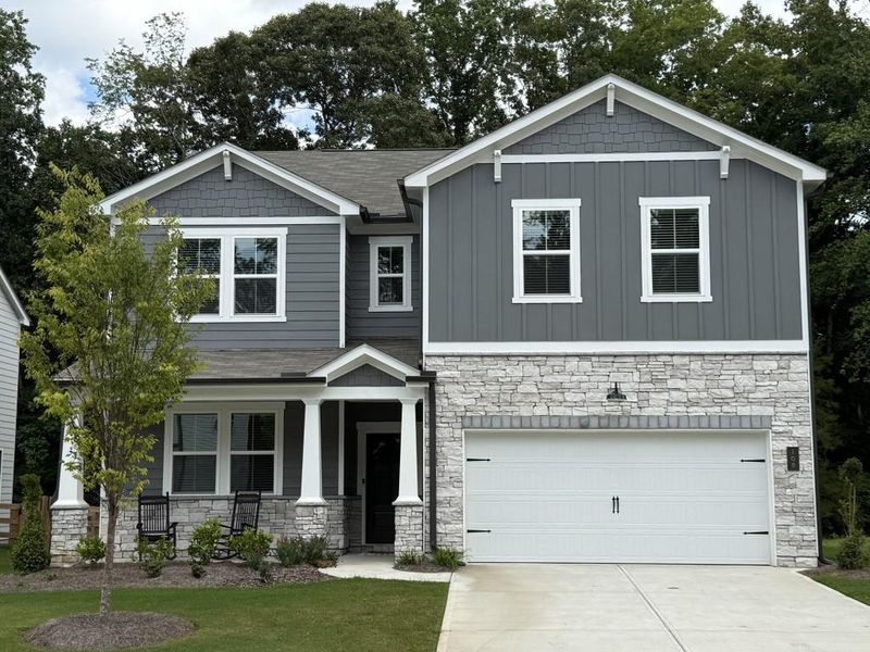 Front exterior of a new home in Cambridge at Steels Bridge, Canton, GA, highlighting curb appeal (Image 1). Front exterior of a new home in Cambridge at Steels Bridge, Canton, GA, highlighting curb appeal (Image 1).