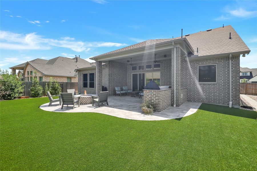 Upgraded patio with fireplace, pavers and artificial turf. OVER 60K in upgrades!