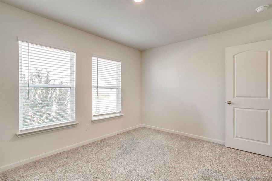 Unfurnished room with light colored carpet and baseboards
