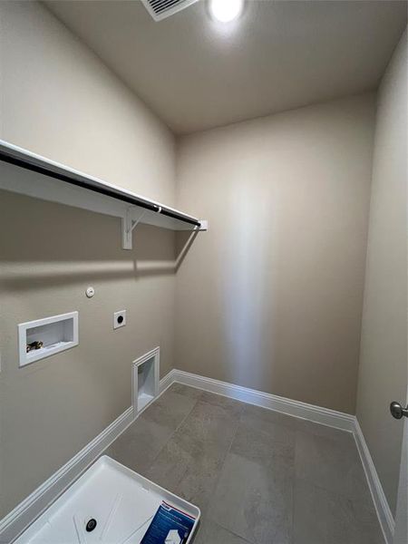 Laundry room with laundry area, baseboards, hookup for a gas dryer, hookup for a washing machine, and electric dryer hookup