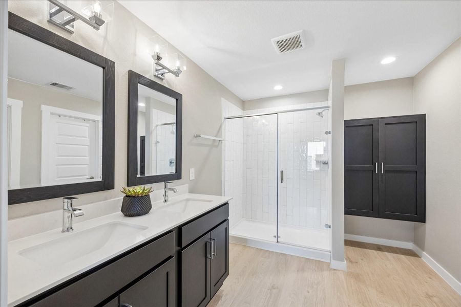 The primary bathroom features quartz countertops, double sinks, chrome designer faucets, walk-in shower and lots of storage.  There is a whole home water softener as well, which is wonderful to have!