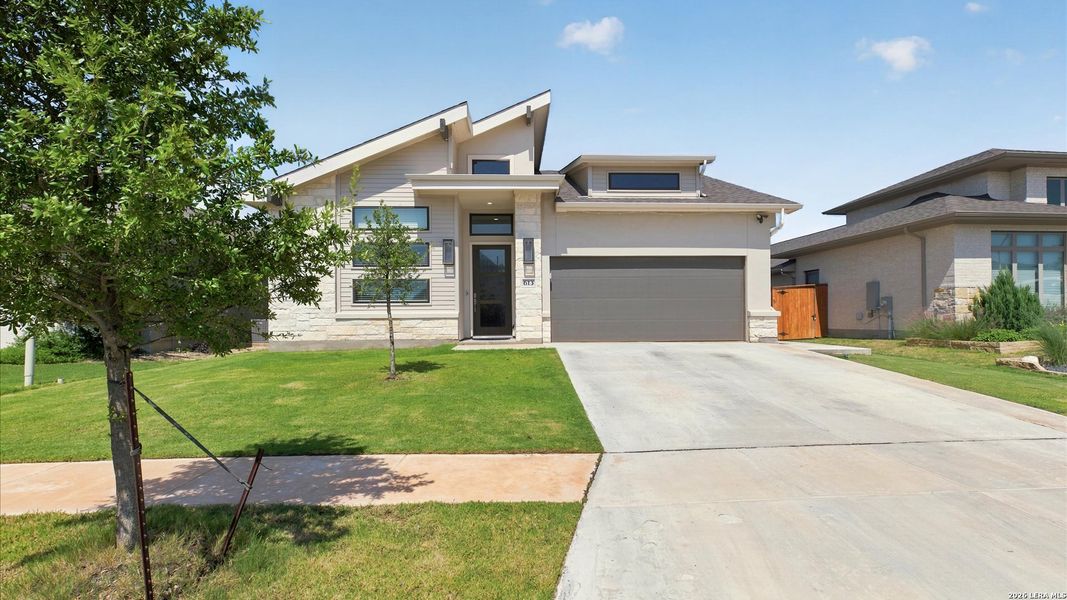 Front exterior of a new home in Veramendi, New Braunfels, TX, highlighting curb appeal (Image 2). Front exterior of a new home in Veramendi, New Braunfels, TX, highlighting curb appeal (Image 2).