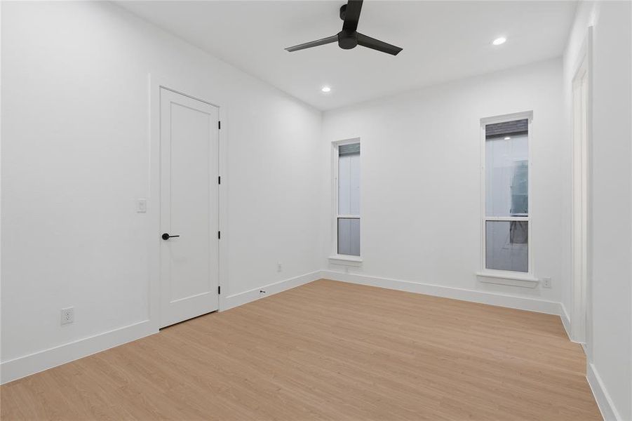 Empty room featuring light wood-style floors, recessed lighting, and a ceiling fan