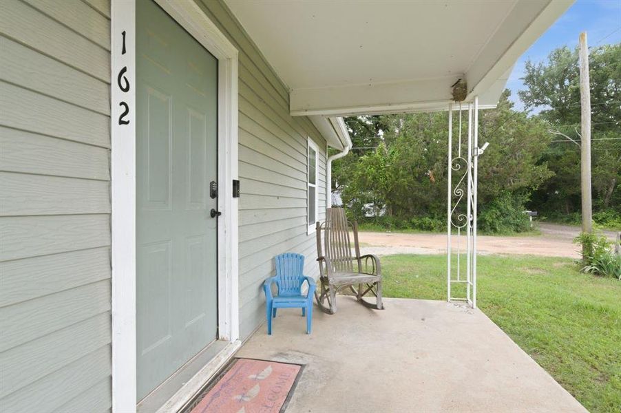 Front porch with light green panel siding