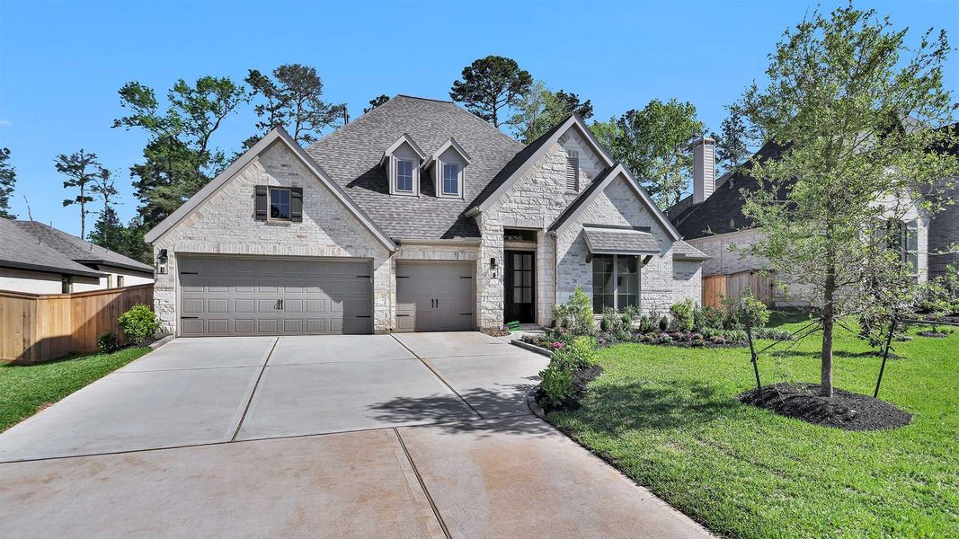 Front exterior of a new home in The Woodlands Hills 75', Willis, TX, highlighting curb appeal (Image 1).