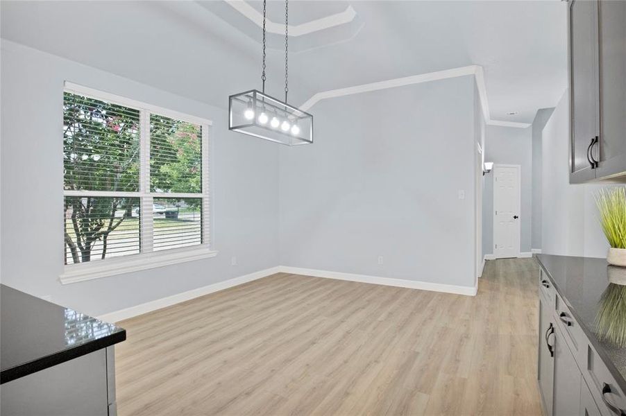 Eat-in dining area featuring an inviting chandelier, and built-in hutch.