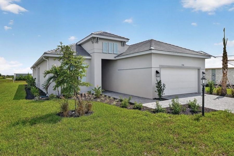 Front exterior of a new home in Skye Ranch Community Group Page, Sarasota, FL, highlighting curb appeal (Image 18). Front exterior of a new home in Skye Ranch Community Group Page, Sarasota, FL, highlighting curb appeal (Image 18).