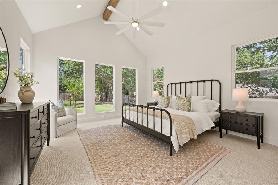 Bedroom featuring beamed ceiling, high vaulted ceiling, light colored carpet, a ceiling fan, and recessed lighting Bedroom featuring beamed ceiling, high vaulted ceiling, light colored carpet, a ceiling fan, and recessed lighting
