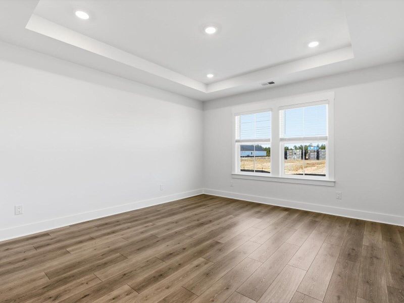 Spacious, unfurnished interior of a new home in The Coves at Lakes of Cane Bay, Summerville (Image 39).