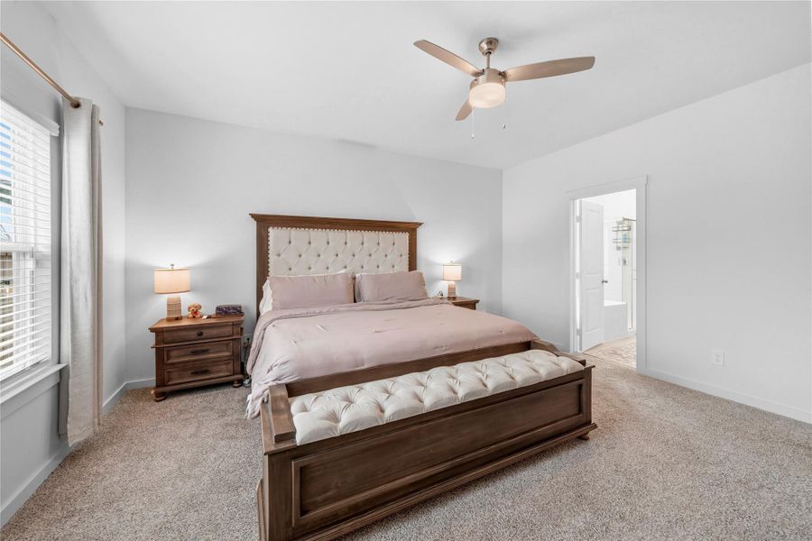 From this angle, the primary suite showcases sunlit windows and seamless access to a private en-suite bathroom, creating a serene retreat. From this angle, the primary suite showcases sunlit windows and seamless access to a private en-suite bathroom, creating a serene retreat.