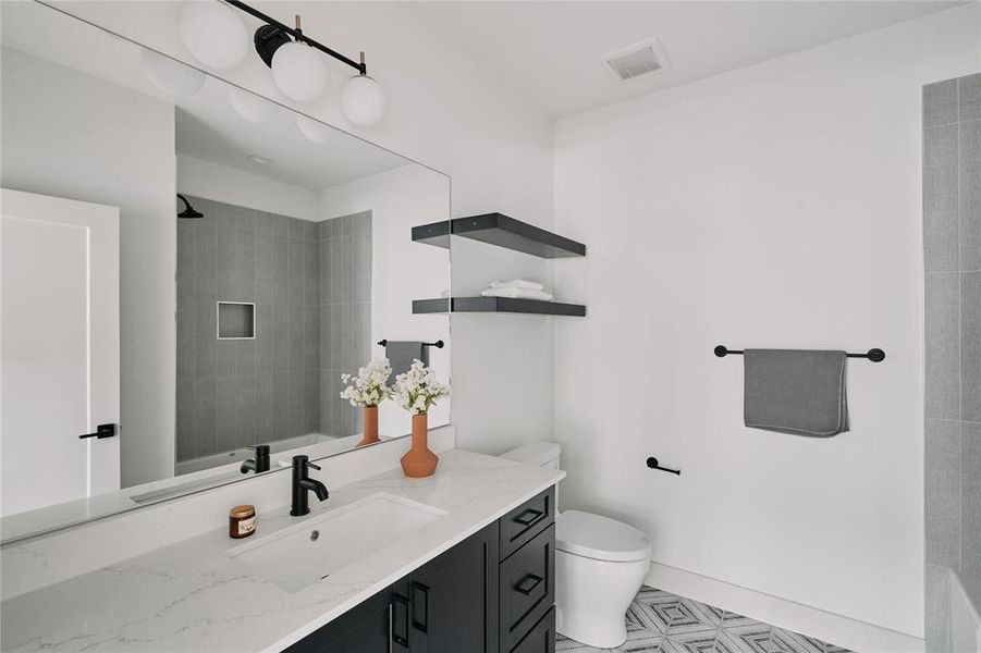 Bathroom featuring a dark wood-finish vanity with a white countertop and integrated sink
