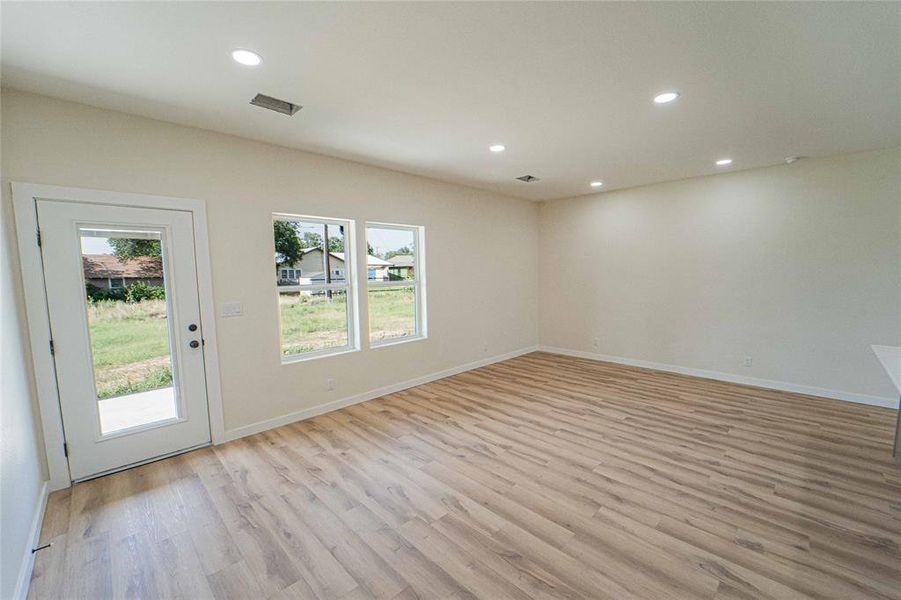 Large and open concept Living area looks out onto back patio area