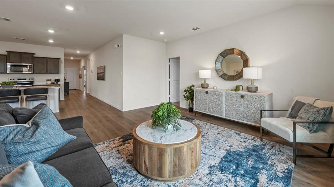 Living area with dark wood-style floors and recessed lighting Living area with dark wood-style floors and recessed lighting
