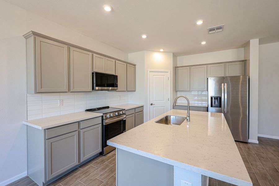 A kitchen with white cabinets. A kitchen with white cabinets.