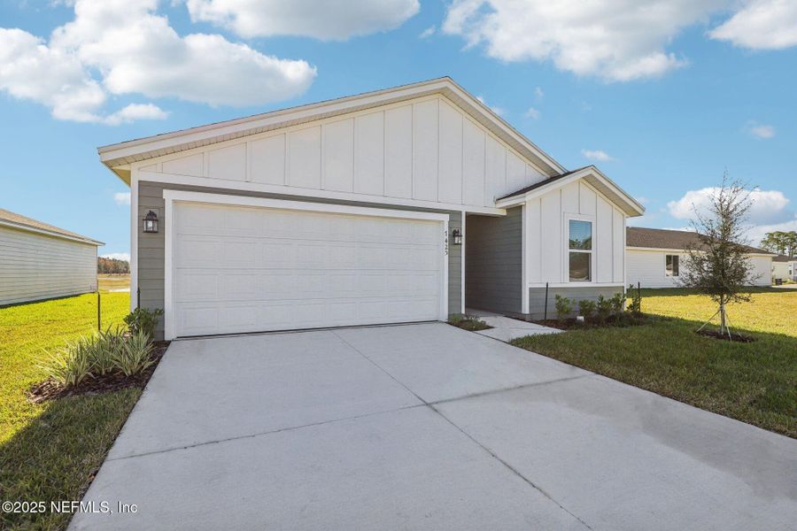 Front exterior of a new home in Cypress Meadows - Signature Series, Jacksonville, FL, highlighting curb appeal (Image 19).