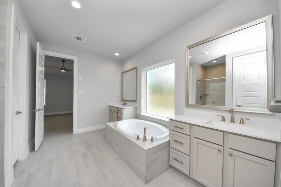 Elevate your daily routine at the elegant vanity, now equipped with double sinks, light countertops, modern hardware, and beautiful recessed lights. Elevate your daily routine at the elegant vanity, now equipped with double sinks, light countertops, modern hardware, and beautiful recessed lights.