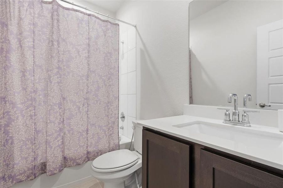 Bathroom featuring a white vanity with a rectangular undermount sink, chrome faucet, and dark wood-finish cabinetry