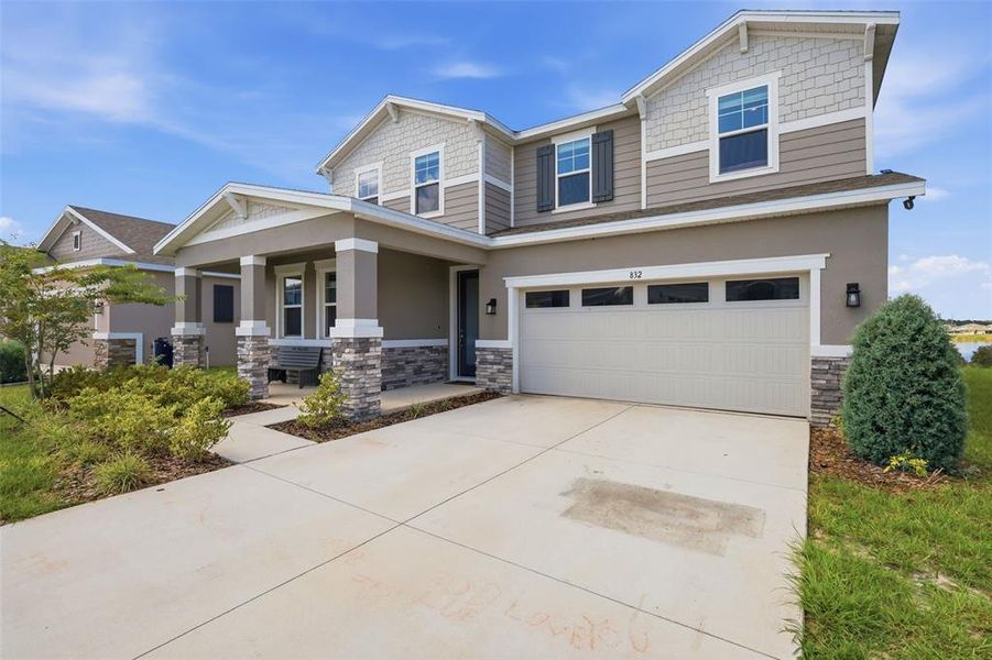 Front exterior of a new home in Seasons at Eden Hills, Lake Alfred, FL, highlighting curb appeal (Image 25). Front exterior of a new home in Seasons at Eden Hills, Lake Alfred, FL, highlighting curb appeal (Image 25).