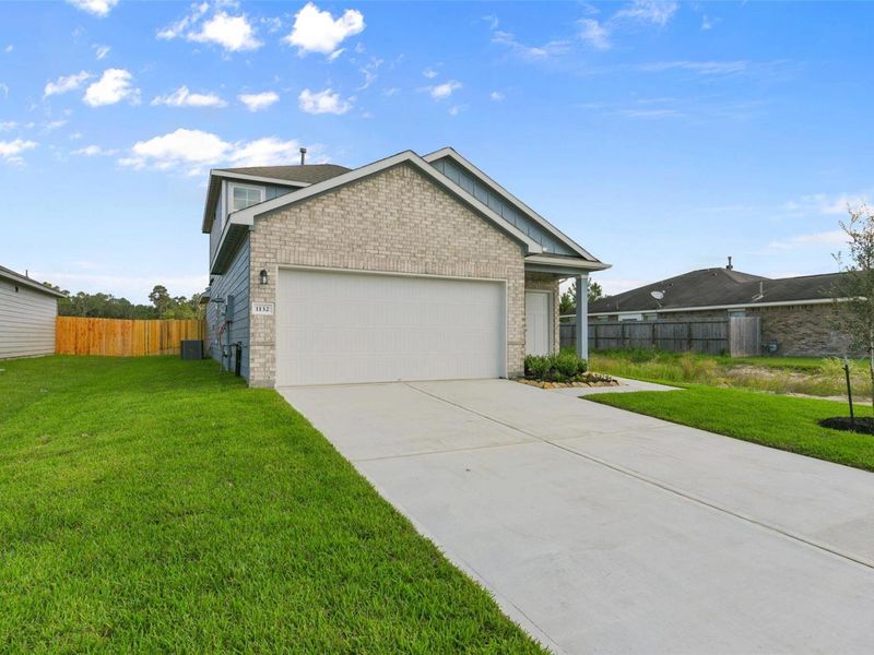 Front exterior of a new home in The Villages at WestPointe, Dayton, TX, highlighting curb appeal (Image 2).