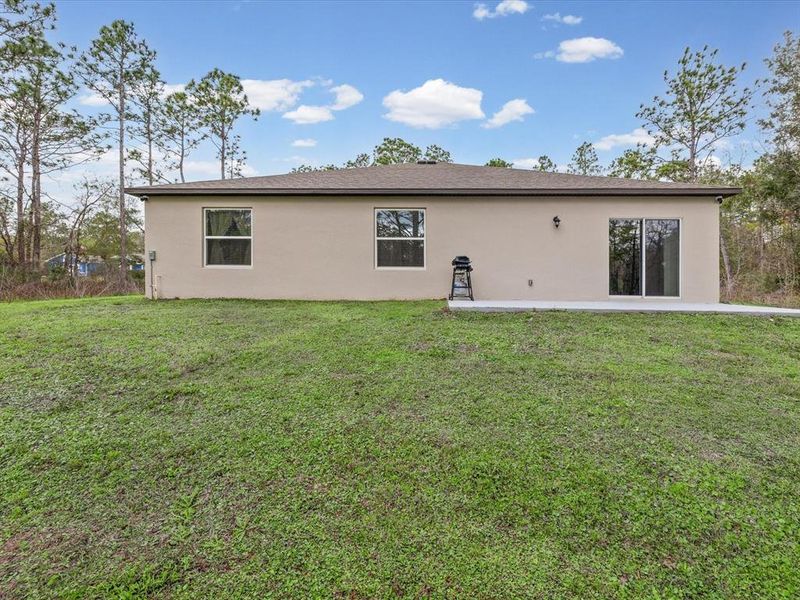Exterior details and patio area of a home in Royal Highlands, Brooksville (Image 22).