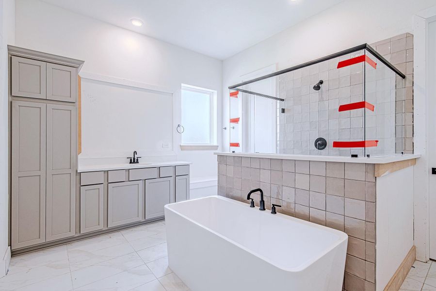 Frameless glass shower enclosure with dual showerheads adds a touch of elegance