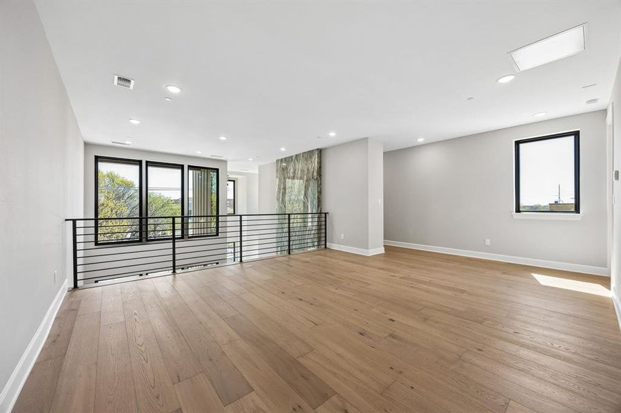 Spare room featuring light wood finished floors and recessed lighting Spare room featuring light wood finished floors and recessed lighting