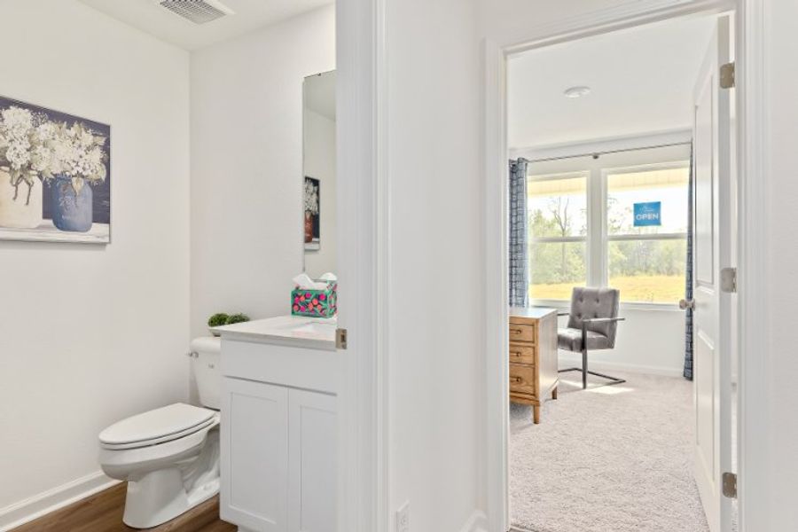 A bathroom with a chair and a sink.