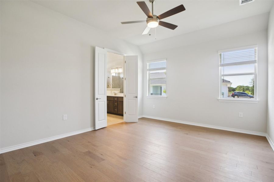 Unfurnished room with light wood-style flooring and ceiling fan Unfurnished room with light wood-style flooring and ceiling fan