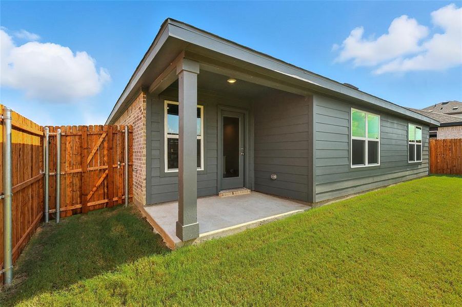 Back of house featuring a fenced backyard, a gate, and a patio area Back of house featuring a fenced backyard, a gate, and a patio area