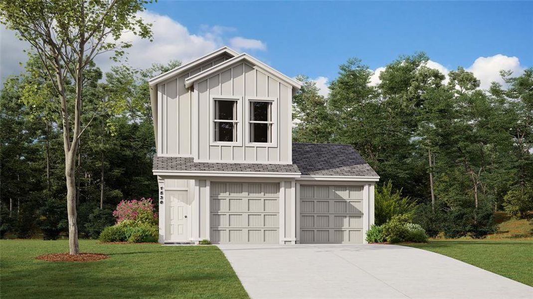 View of front facade featuring a garage and a front yard