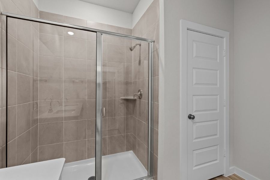 A shower with a glass door.