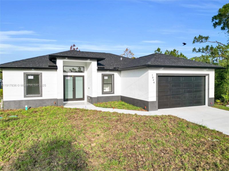 Front exterior of a new home in , Lehigh Acres, FL, highlighting curb appeal (Image 2). Front exterior of a new home in , Lehigh Acres, FL, highlighting curb appeal (Image 2).