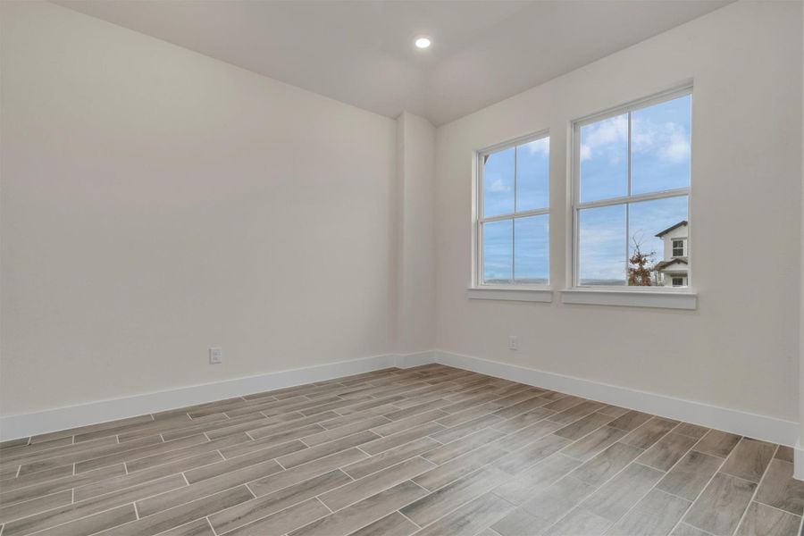 The simple elegance of this room is elevated by modern wood-look tile flooring.