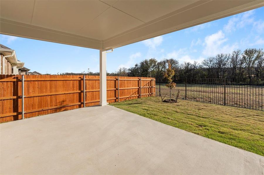 Fenced backyard with a patio area Fenced backyard with a patio area