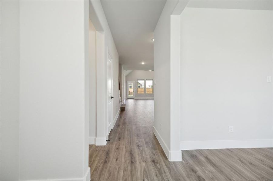 Hallway with light hardwood / wood-style floors