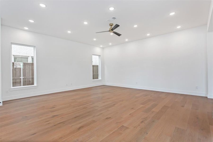 Unfurnished room with ceiling fan and light hardwood / wood-style flooring