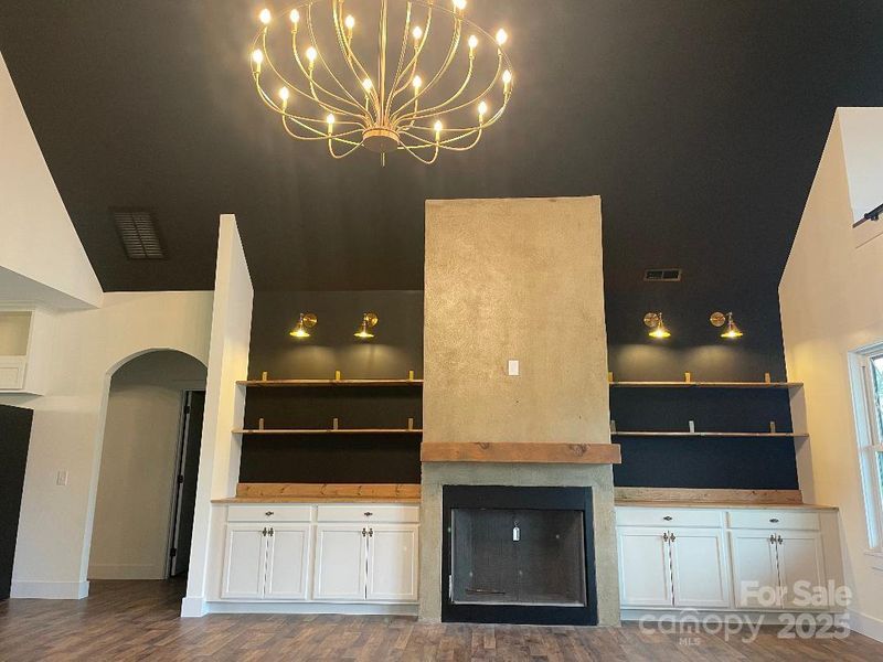 Beautiful custom built ins surround the fireplace with gas logs.