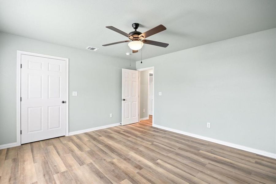 Spare room featuring hardwood / wood-style floors and ceiling fan