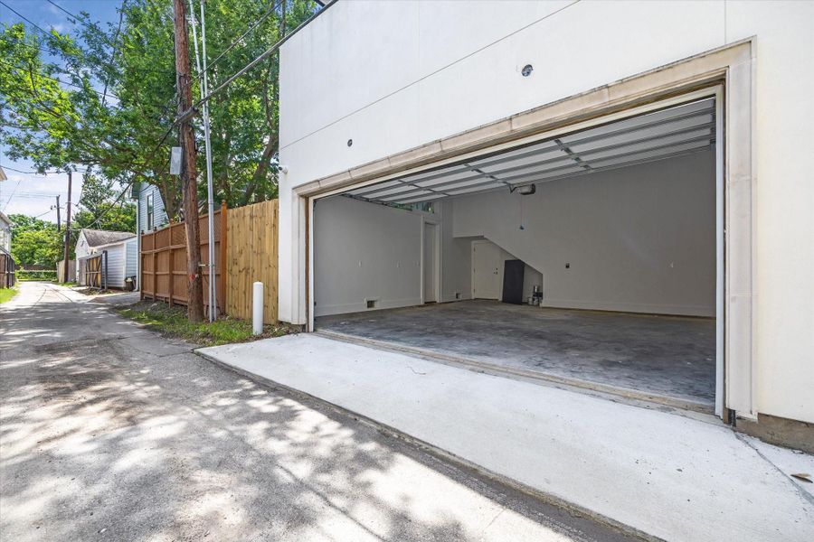 The spacious two-car garage with a clean concrete floor has an automatic garage door opener and  access from a back alley. The garage is attached and opens into the back hall/mudroom of the house and also to the covered outdoor patio.  There is a wooden fence, offering privacy.