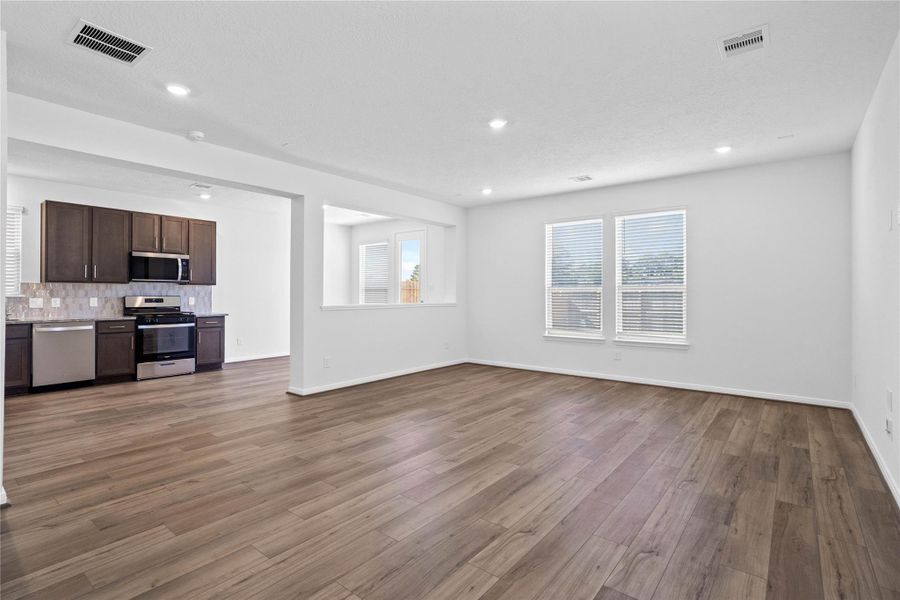 Stunning open-concept design seamlessly connecting the living, dining, and kitchen areas—perfect for both everyday living and entertaining!