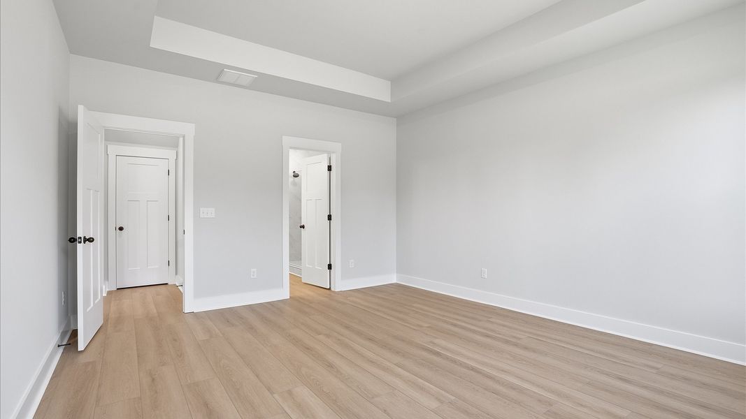 First-class hardwood floors and tasteful finishes elevate the private retreat of this exceptional primary suite in Woodruff First-class hardwood floors and tasteful finishes elevate the private retreat of this exceptional primary suite in Woodruff