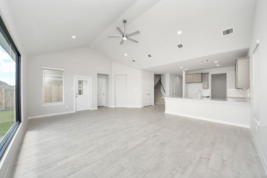 Gather the family and guests together in your lovely living room! Featuring soaring high ceilings, recessed lighting, ceiling fan, custom paint, gorgeous floors, and large windows that provide plenty of natural lighting throughout the day. Gather the family and guests together in your lovely living room! Featuring soaring high ceilings, recessed lighting, ceiling fan, custom paint, gorgeous floors, and large windows that provide plenty of natural lighting throughout the day.