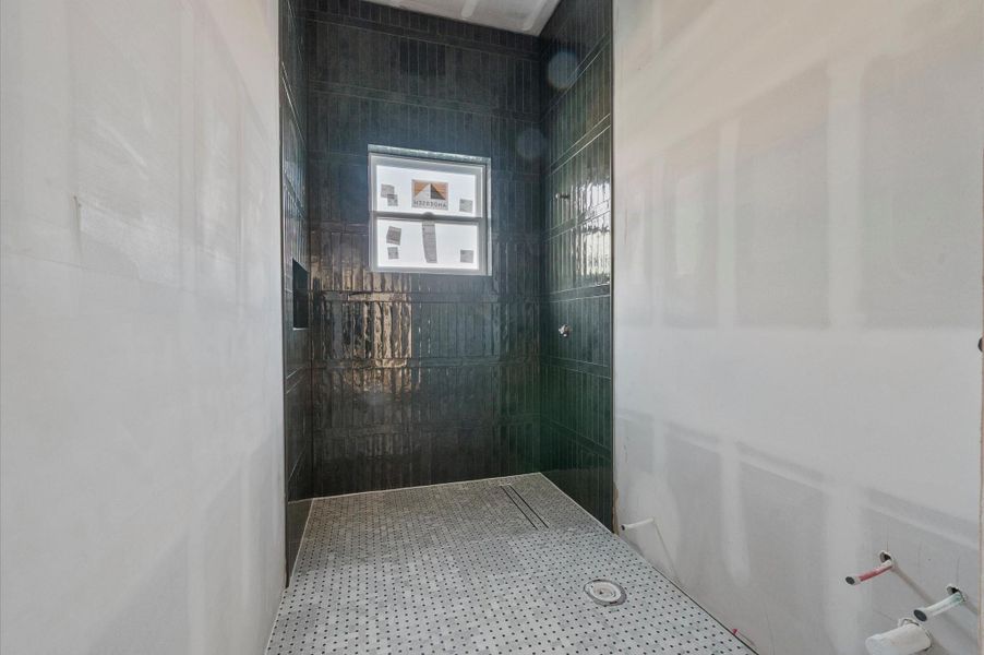 Downstairs powder bath designed with a moody, elevated aesthetic, featuring a walk-in shower. A Calacatta Viola marble sink will complete the space, adding a bold and sophisticated statement.