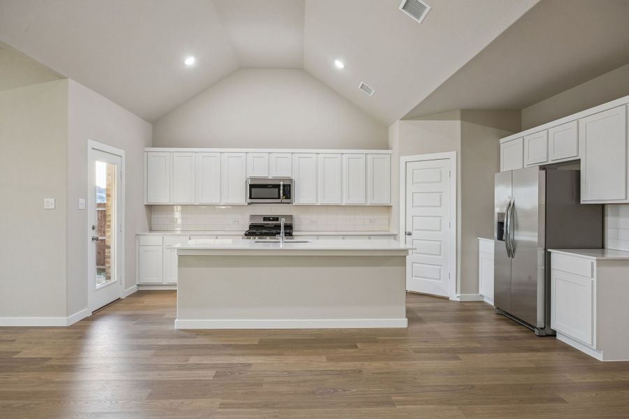 Kitchen in the Wimbledon home plan by Trophy Signature Homes – REPRESENTATIVE PHOTO