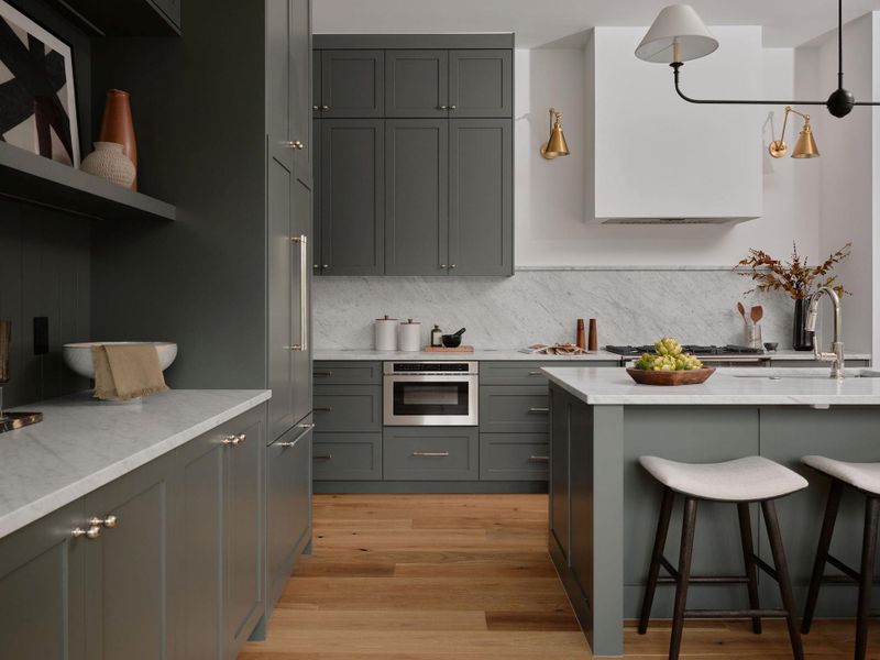 Kitchen with open shelves, light wood finished floors, a kitchen breakfast bar, and light stone countertops Kitchen with open shelves, light wood finished floors, a kitchen breakfast bar, and light stone countertops